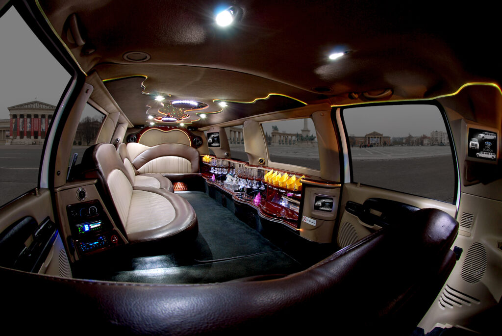 Luxurious interior of a Ford Excursion Limousine in Budapest, featuring elegant leather seating, ambient lighting, and a fully equipped bar for an unforgettable travel experience.