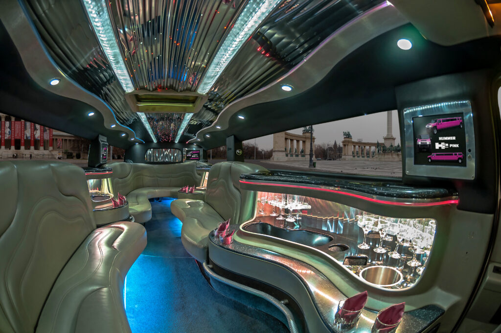The luxurious interior of the Hummer Limousine XL in Budapest, featuring elegant leather seating, LED lighting, and a stocked minibar.