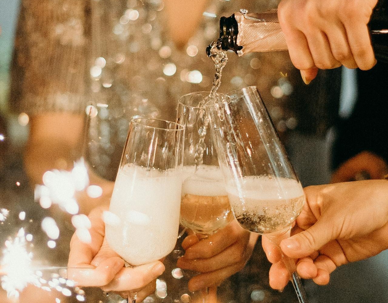 Celebratory champagne being poured into glasses, symbolizing a luxurious party transfer service with elegance and style.