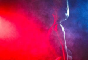 Lady in erotic lights represents strip limo in Budapest.