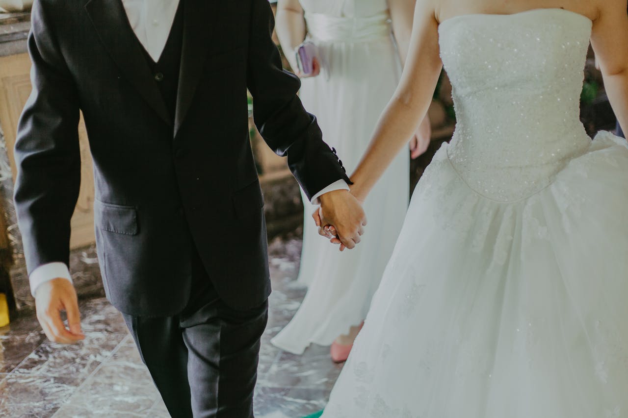 A bride and groom holding hands, representing the elegance and style of arriving at your wedding with exlcusive transportation services in Budapest.