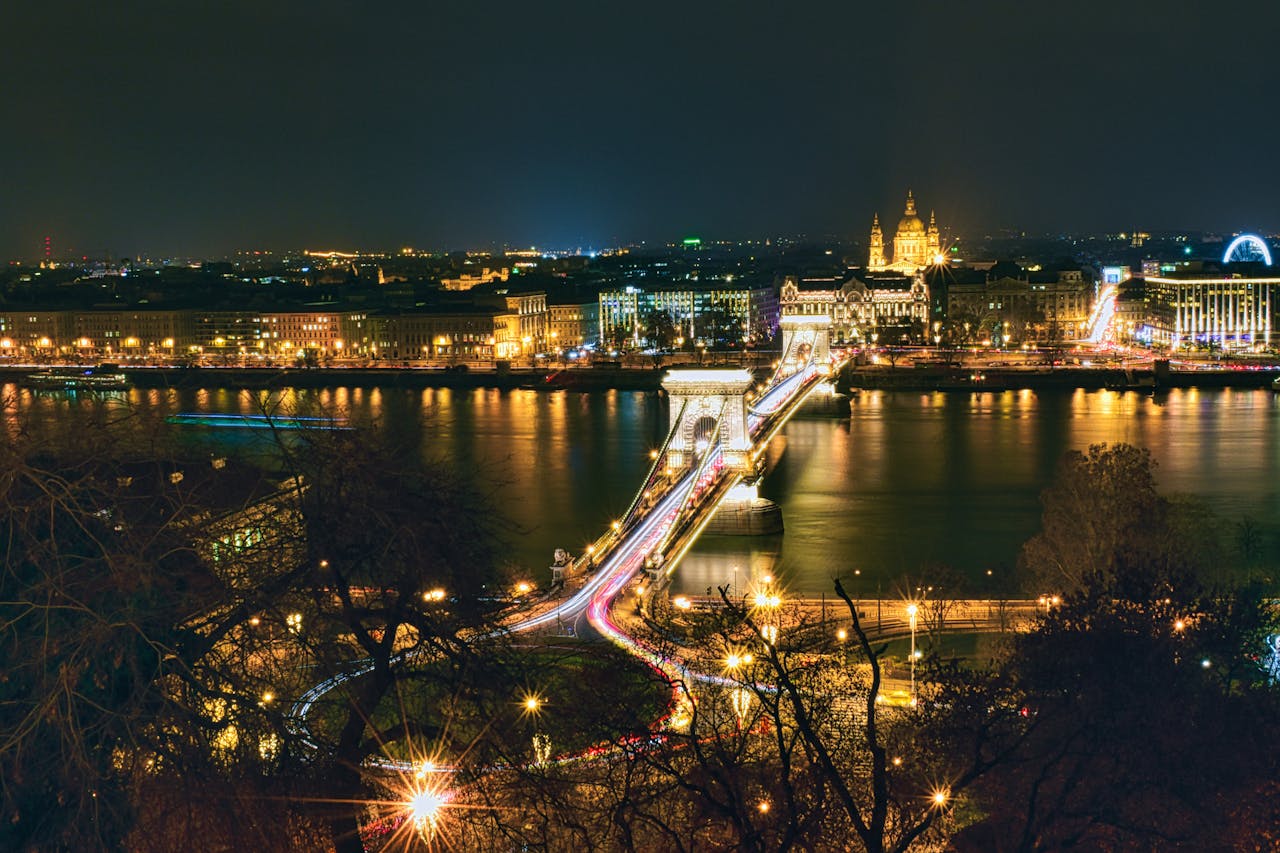 A stunning nighttime view of Budapest with the Chain Bridge illuminated, representing the luxurious experience of a Limousine Rental Budapest ride through the city.