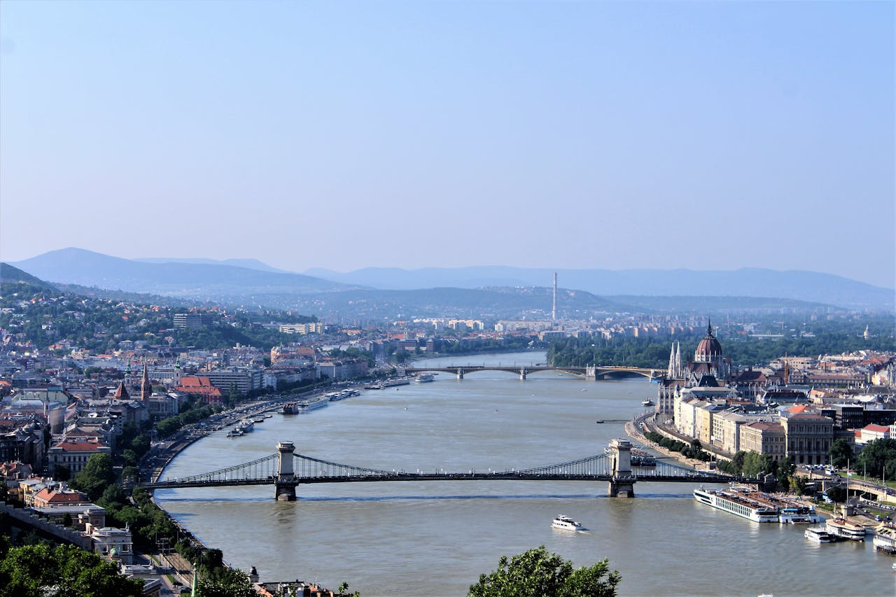 A breathtaking view of Budapest's Danube River and iconic landmarks, the perfect backdrop for a luxurious sightseeing tour with our transportation services.