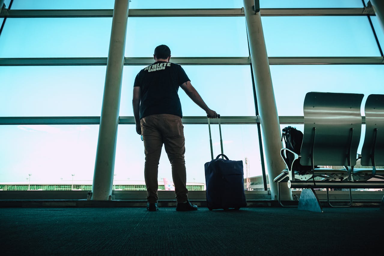 Guy with hand luggage represents airport transfer in Budapest for stag parties.