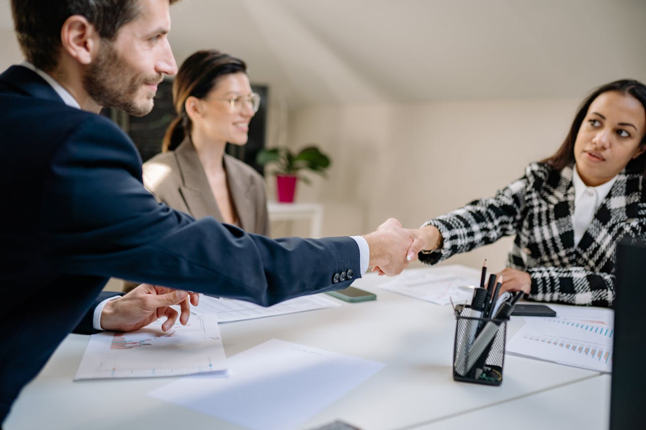 Professional business meeting sealed with a handshake, enhanced by the prestigious touch of a Hummer Limousine XXL Budapest for corporate travel.