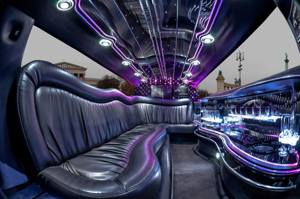 Luxurious Hummer limousine interior with leather seating and neon lights, offering a VIP sightseeing experience near Heroes’ Square in Budapest.