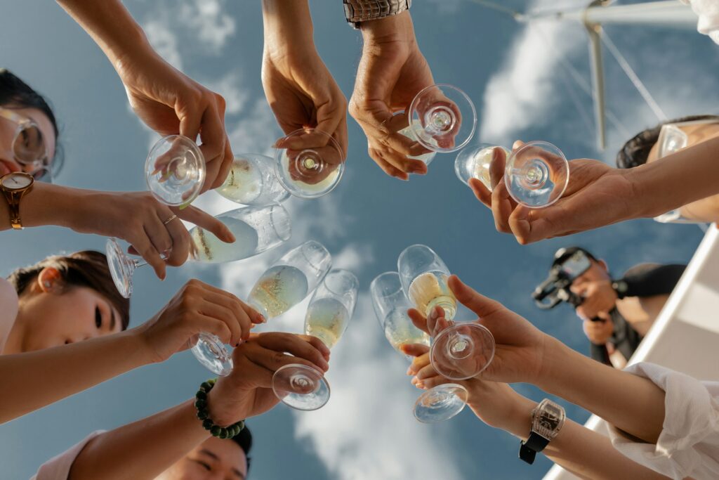 Friends raising champagne glasses during a hen party limo tour in Budapest.