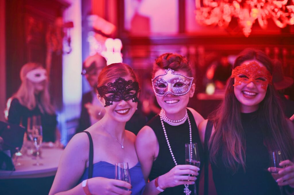Group of friends in masks celebrating a luxury limo party in Budapest