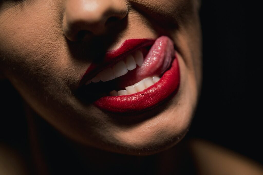 Close-up of red lips with playful expression, reflecting the surprise entertainment during a stag party limo ride in Budapest