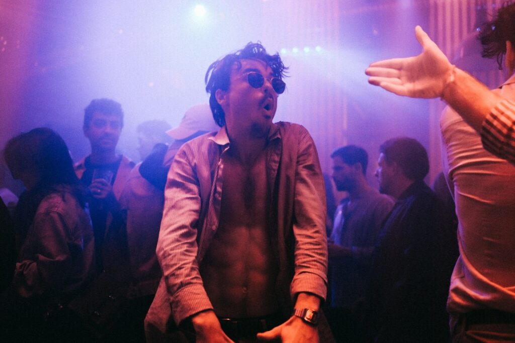 Man enjoying Budapest nightlife during a stag transfer experience, representing the fun atmosphere of limousine party transfers.