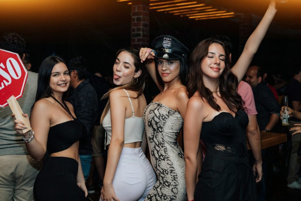 Group of women celebrating a hen party in Budapest nightclub, representing bachelorette limousine rental Budapest and luxury party limo hire.