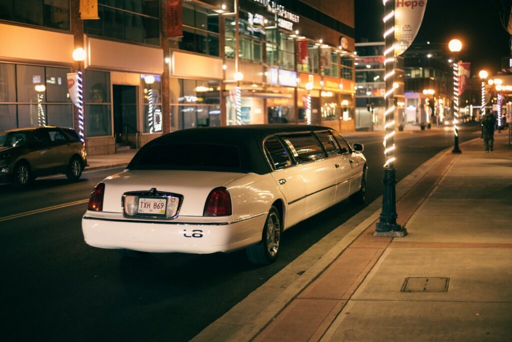 A white stretch limousine parked under city lights in Budapest, representing premium limousine rental Budapest packages for parties and tours.