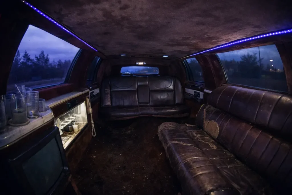 Worn limousine interior with dirty seating and flickering LED lights, example of bad condition limo experience to avoid in Budapest